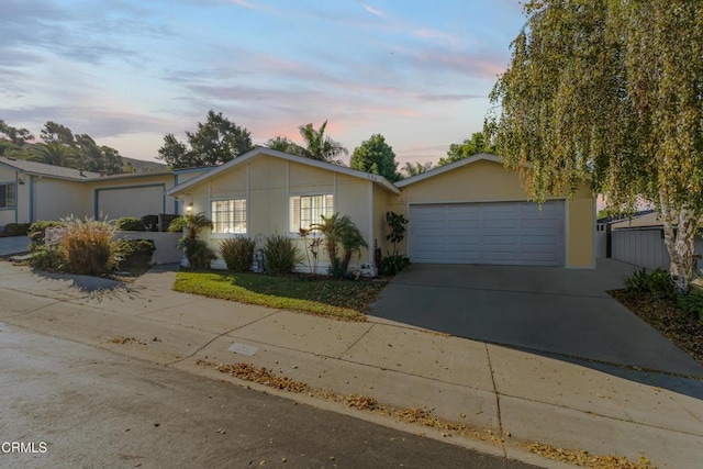 ranch-style house featuring concrete driveway and a garage