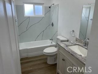 full bath with shower / tub combination, toilet, vanity, and wood finished floors