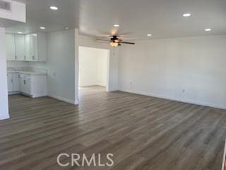 unfurnished living room featuring recessed lighting, baseboards, wood finished floors, and a ceiling fan