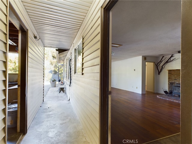 corridor featuring unfinished concrete flooring