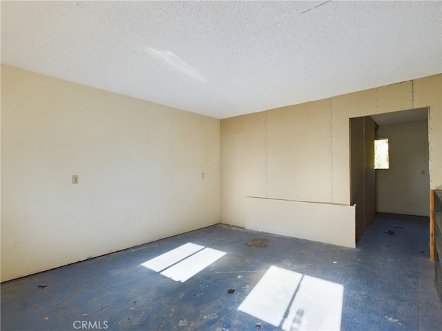 spare room with a textured ceiling