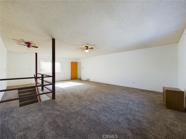 spare room featuring carpet flooring, a textured ceiling, and a ceiling fan