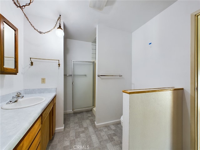 full bathroom featuring tile patterned floors, toilet, a shower with door, baseboards, and vanity