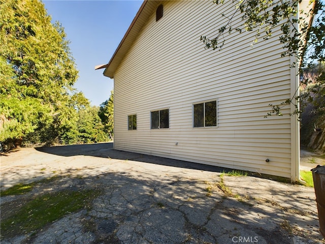 view of side of property with aphalt driveway