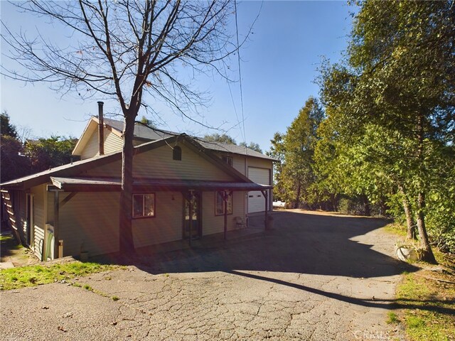 exterior space with a garage and aphalt driveway