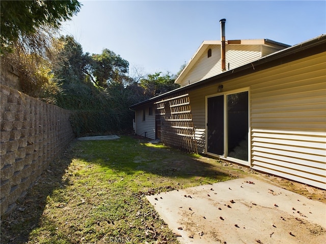 view of yard featuring a patio area and fence