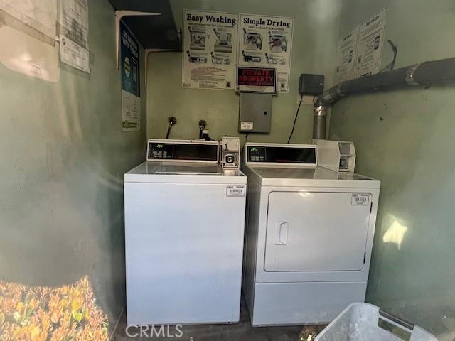 shared laundry area with washing machine and clothes dryer