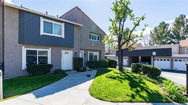 view of front facade featuring stucco siding and a front lawn