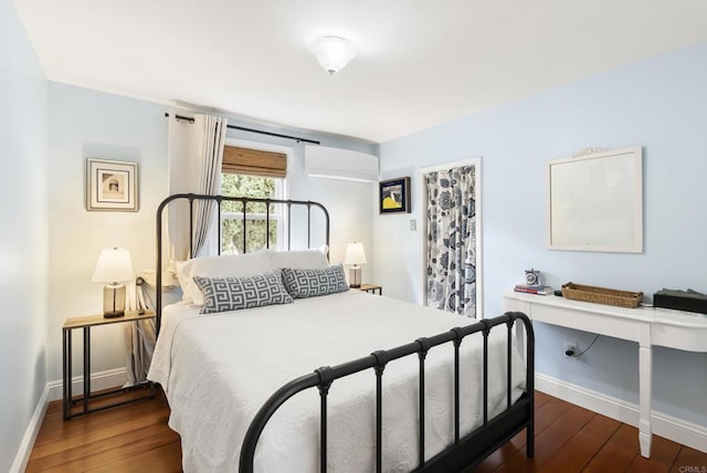 bedroom featuring baseboards and hardwood / wood-style flooring