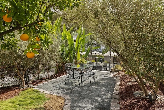 view of patio with outdoor dining area and fence