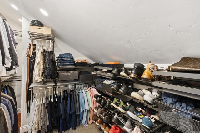 spacious closet featuring vaulted ceiling and carpet