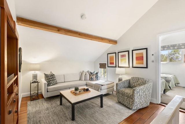 living room featuring lofted ceiling with beams, baseboards, and wood-type flooring