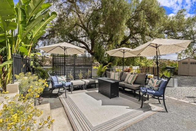 view of patio featuring a fenced backyard, an outdoor living space, a storage unit, and an outdoor structure