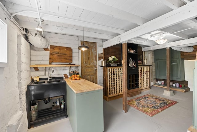 wine cellar featuring finished concrete floors and a sink