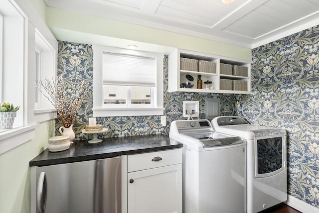 washroom featuring cabinet space, washing machine and dryer, and wallpapered walls