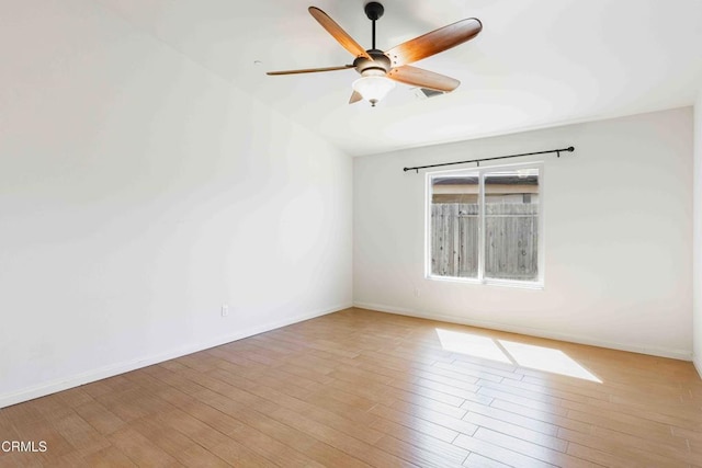 empty room with baseboards and wood finished floors