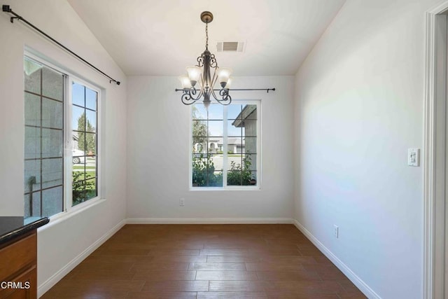 unfurnished dining area featuring baseboards, visible vents, lofted ceiling, dark wood-style flooring, and a notable chandelier