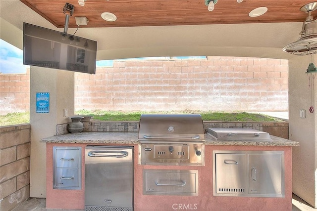 view of patio / terrace featuring area for grilling, a grill, and fence