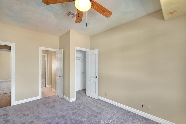 unfurnished bedroom featuring visible vents, a ceiling fan, a closet, carpet floors, and baseboards