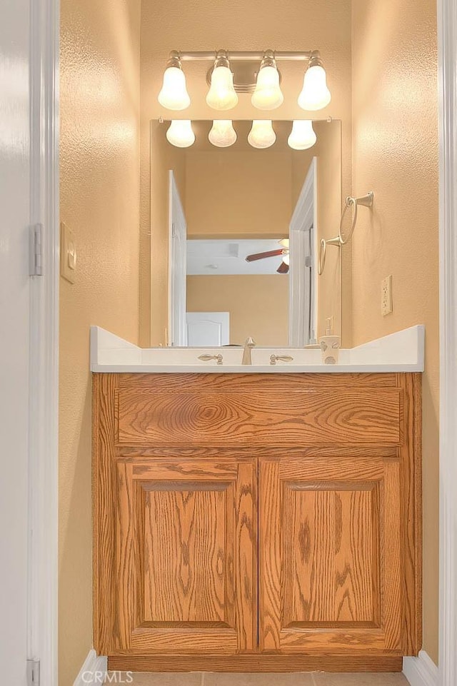 bathroom with ceiling fan and vanity