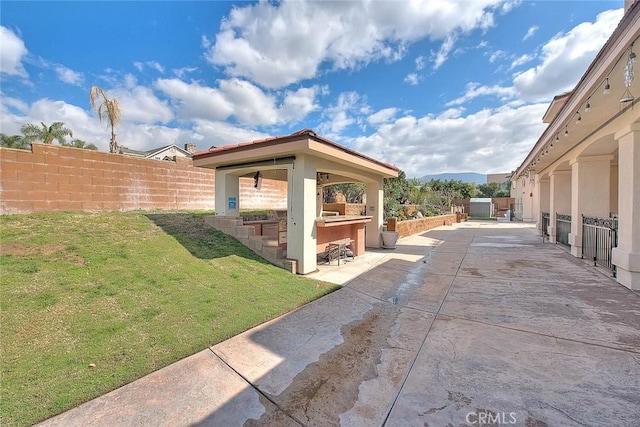 surrounding community featuring outdoor dry bar, a gazebo, a yard, a fenced backyard, and a patio