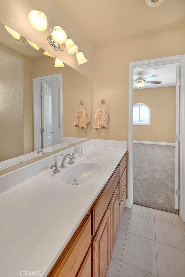 bathroom with baseboards, vanity, and tile patterned flooring