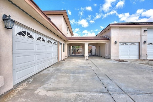 garage featuring concrete driveway