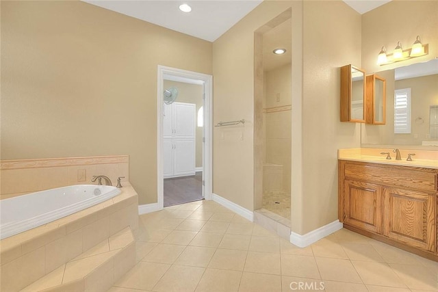 full bath featuring tiled shower, a bath, vanity, and tile patterned flooring