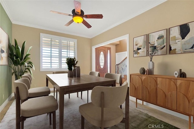 dining room featuring ceiling fan, stairs, baseboards, and ornamental molding