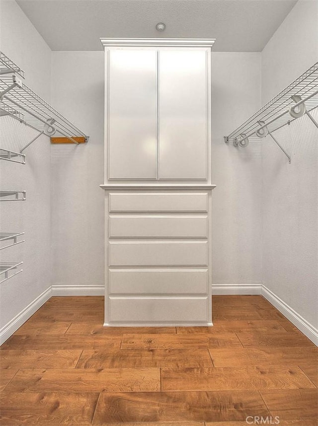 walk in closet featuring wood finished floors