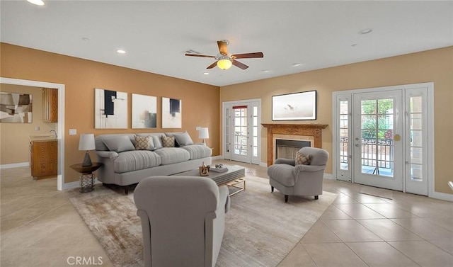 living room with light tile patterned floors, baseboards, recessed lighting, and a fireplace