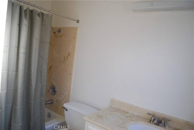 bathroom featuring shower / bath combination with curtain, toilet, and a sink