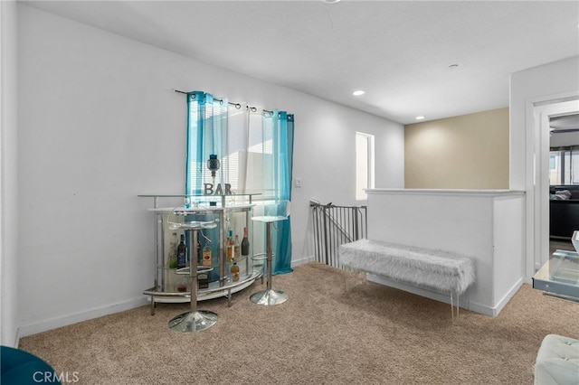 living area featuring an upstairs landing, recessed lighting, baseboards, and carpet floors