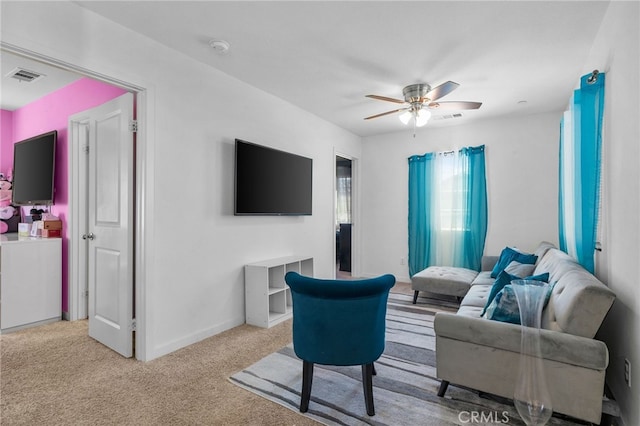 carpeted living room with visible vents, baseboards, and ceiling fan