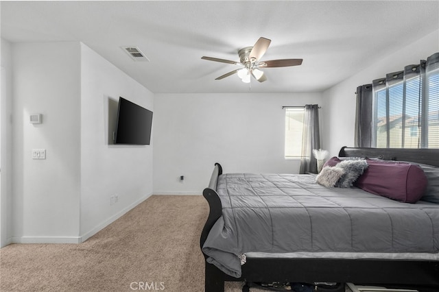 bedroom featuring visible vents, baseboards, carpet, and ceiling fan