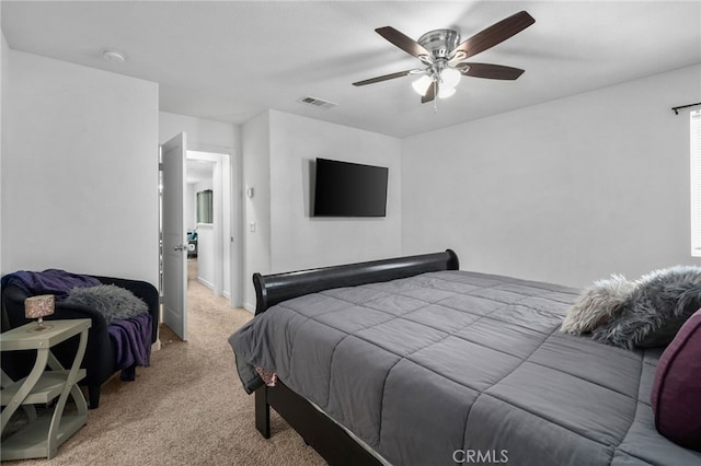 bedroom featuring light carpet, visible vents, and a ceiling fan