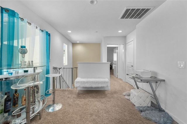 interior space with visible vents, baseboards, an upstairs landing, carpet flooring, and recessed lighting