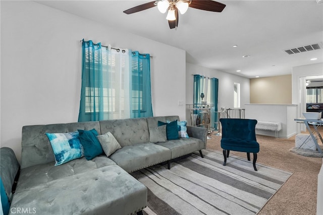 carpeted living area with recessed lighting and visible vents