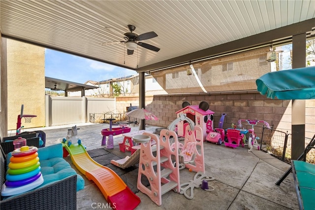 view of patio featuring ceiling fan and fence