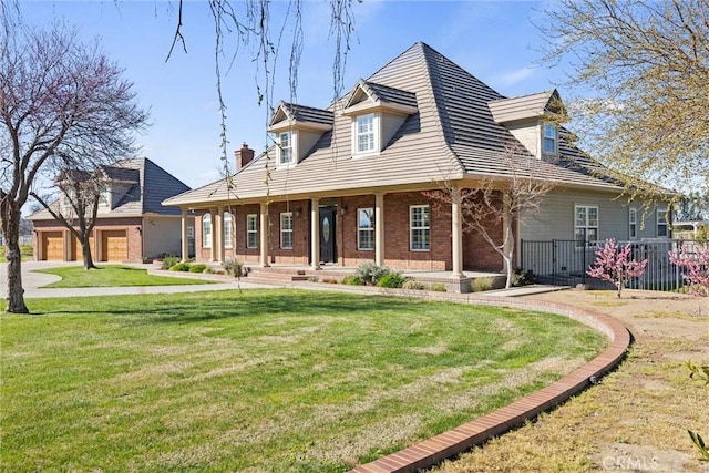 view of front of house with brick siding, a front lawn, and fence