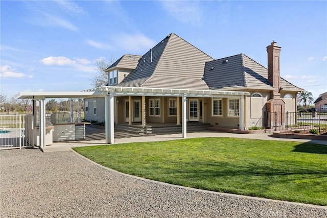 back of property featuring a patio area, a pergola, a yard, and fence