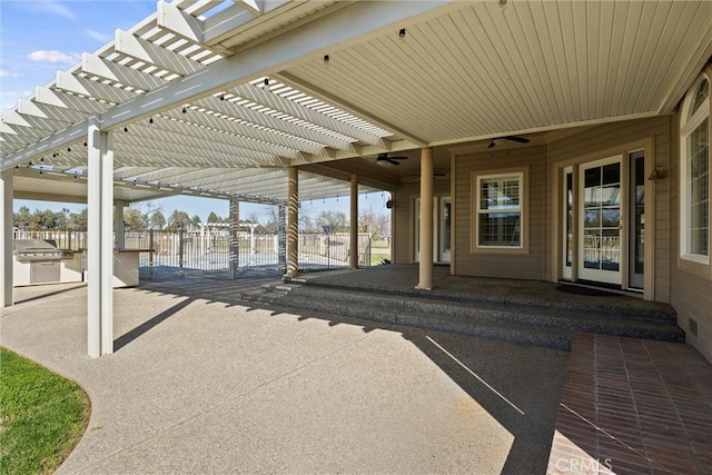 view of patio with grilling area, a pergola, ceiling fan, and fence