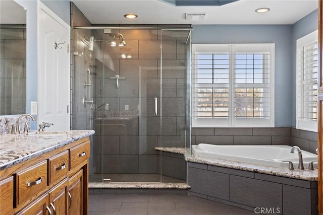 full bathroom with a shower stall, plenty of natural light, and a garden tub