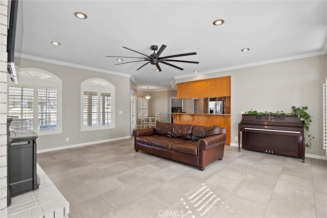 living area featuring ornamental molding, a ceiling fan, recessed lighting, light tile patterned floors, and baseboards