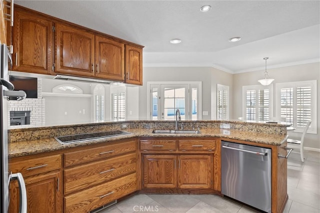 kitchen with dishwasher, black electric cooktop, brown cabinets, and a sink