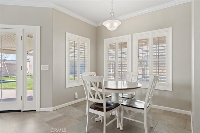 dining room featuring plenty of natural light, baseboards, and ornamental molding