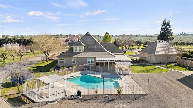 view of pool with a fenced in pool, a yard, a fenced backyard, and a patio area