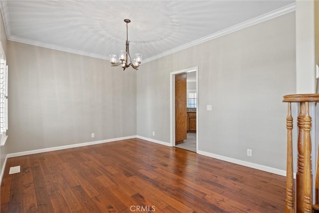 spare room with a chandelier, baseboards, ornamental molding, and dark wood-style flooring