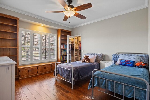 bedroom with ornamental molding, ceiling fan, and dark wood-style flooring