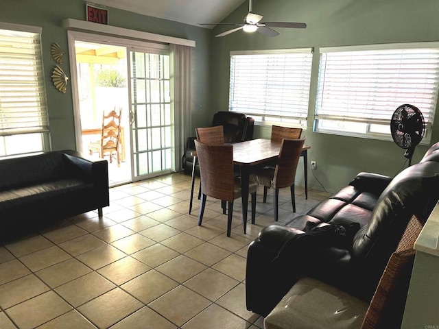 tiled dining area with lofted ceiling, plenty of natural light, and ceiling fan